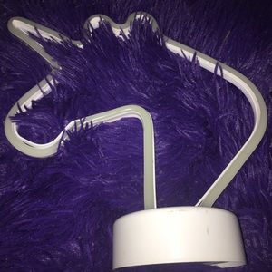 A neon purple unicorn lamp